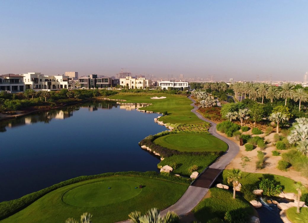 aerial-view-of-flagstick-at-golf-club-on-luxury-residential-area-dubai-uae-SBI-349468875
